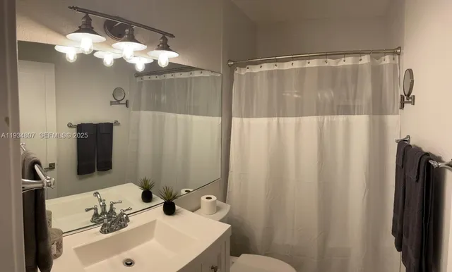 a bathroom with a sink vanity and mirror