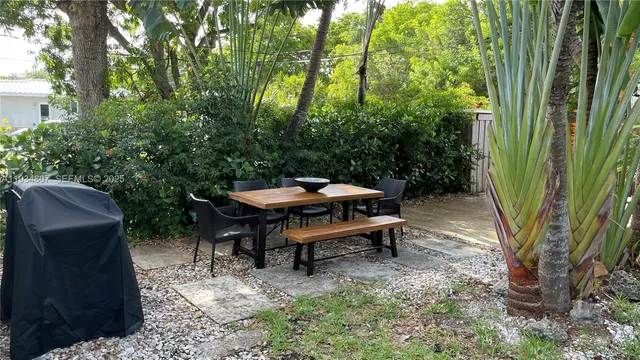 a view of a house with a yard and tree s