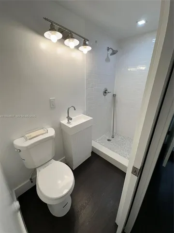 a white toilet sitting next to a bathroom sink