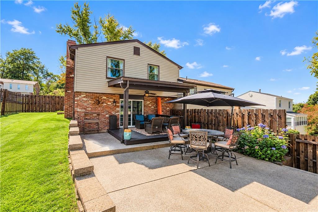 Covered rear deck with additional patio area.