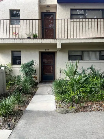 a house with potted plants in front of it