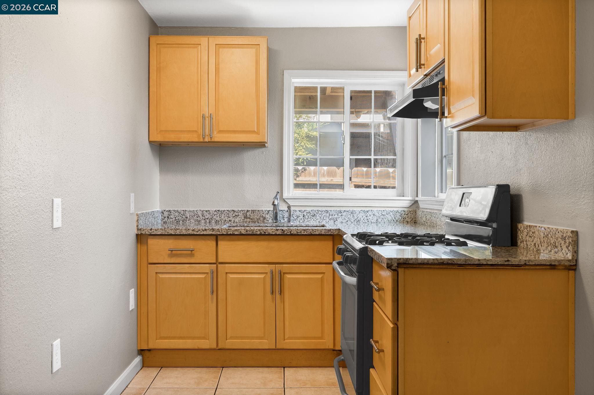 4820 Blum Road Martinez, CA 94553 - Photo 13 of 46 a kitchen with stainless steel appliances granite countertop a sink and cabinets