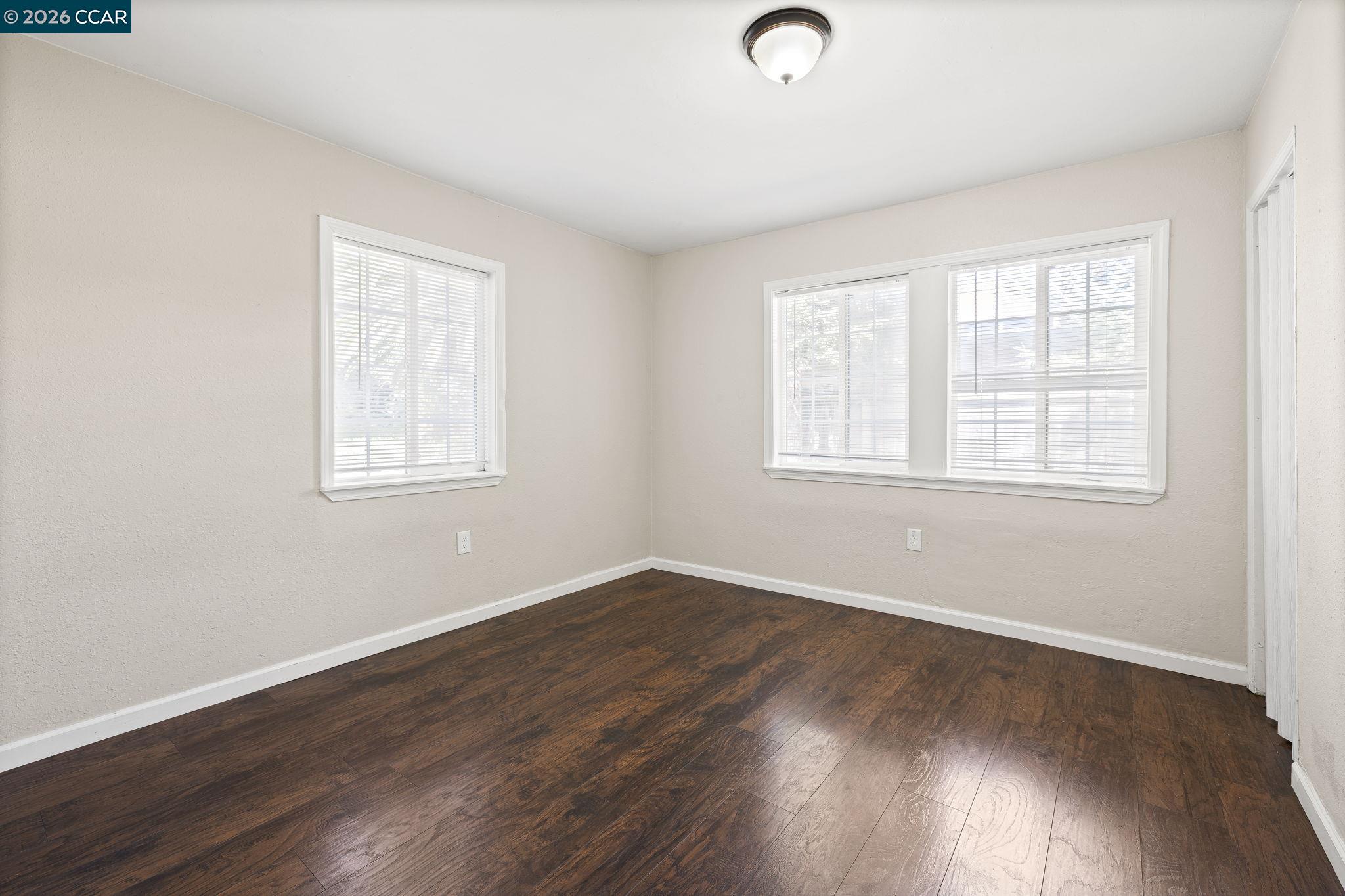 4820 Blum Road Martinez, CA 94553 - Photo 17 of 46 an empty room with wooden floor and windows