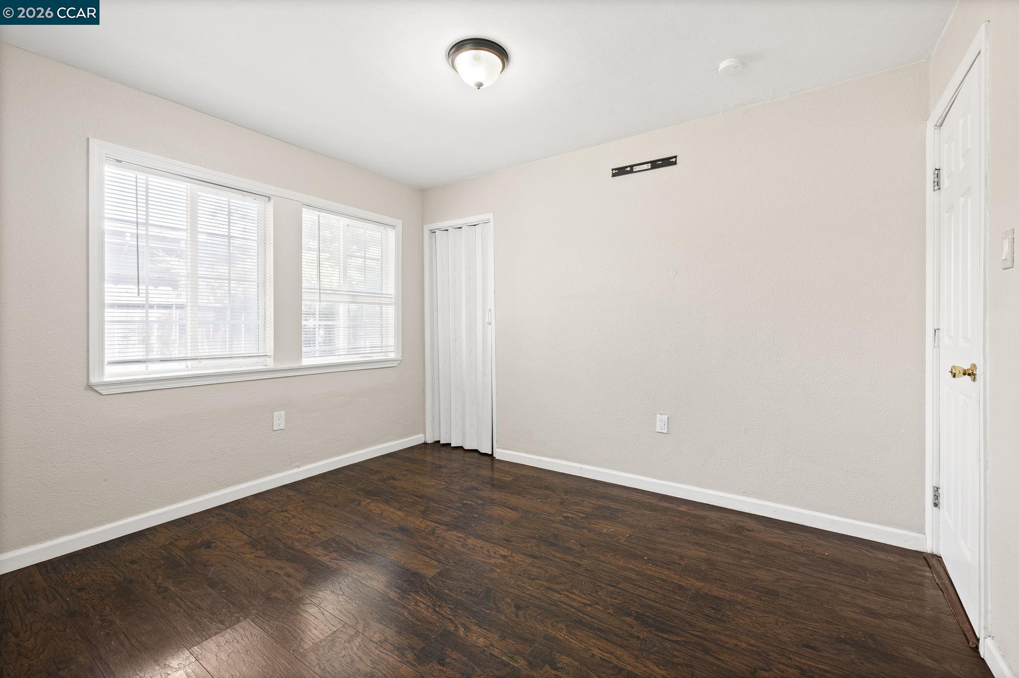 4820 Blum Road Martinez, CA 94553 - Photo 33 of 46 an empty room with wooden floor and windows