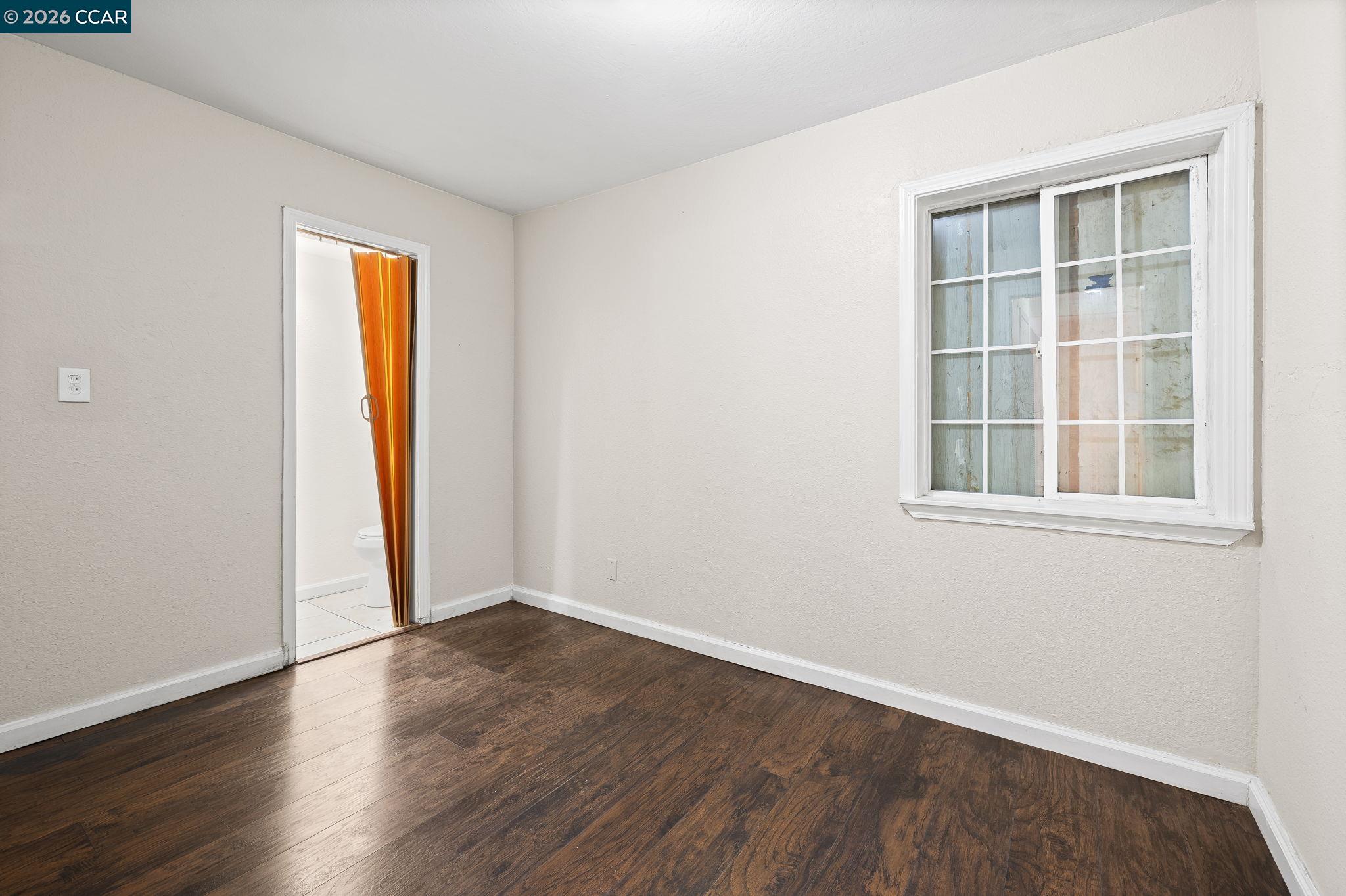 4820 Blum Road Martinez, CA 94553 - Photo 44 of 46 an empty room with wooden floor and windows