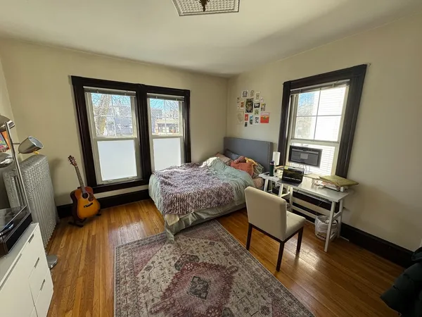 a bedroom with a bed and a window