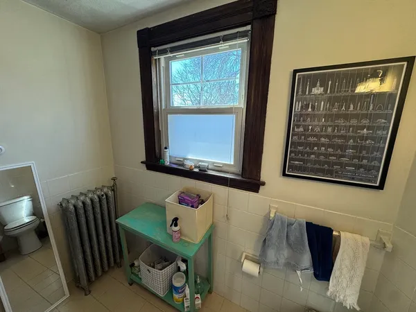 a living room with furniture fireplace and a large window