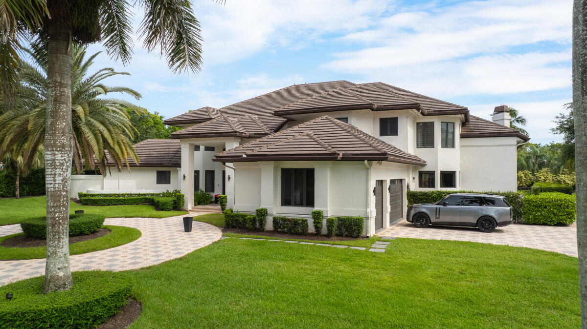 3500 Windmill Ranch Road Weston, FL 33331 - Photo 36 of 47 a front view of a house with a garden and yard