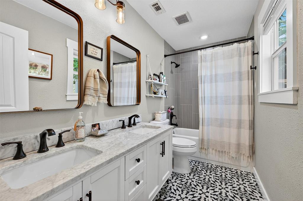 5816 Luella Road Sherman, TX 75090 - Photo 16 of 36 a bathroom with a double vanity sink toilet and shower