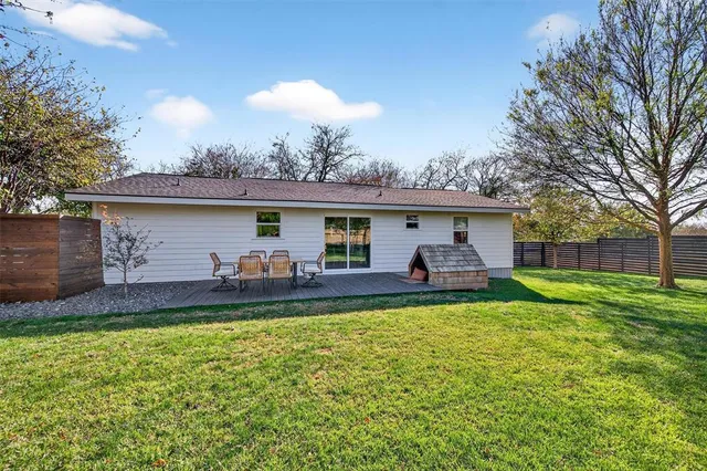a view of a house with a backyard and a patio