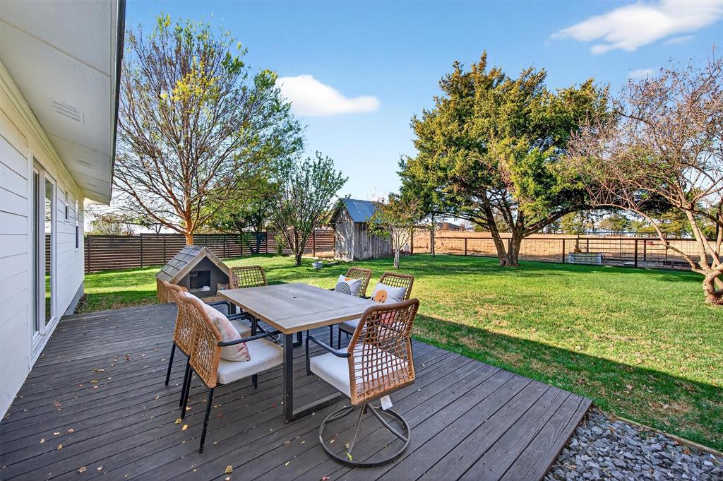 5816 Luella Road Sherman, TX 75090 - Photo 22 of 36 a view of a deck with table and chairs with wooden floor and fence
