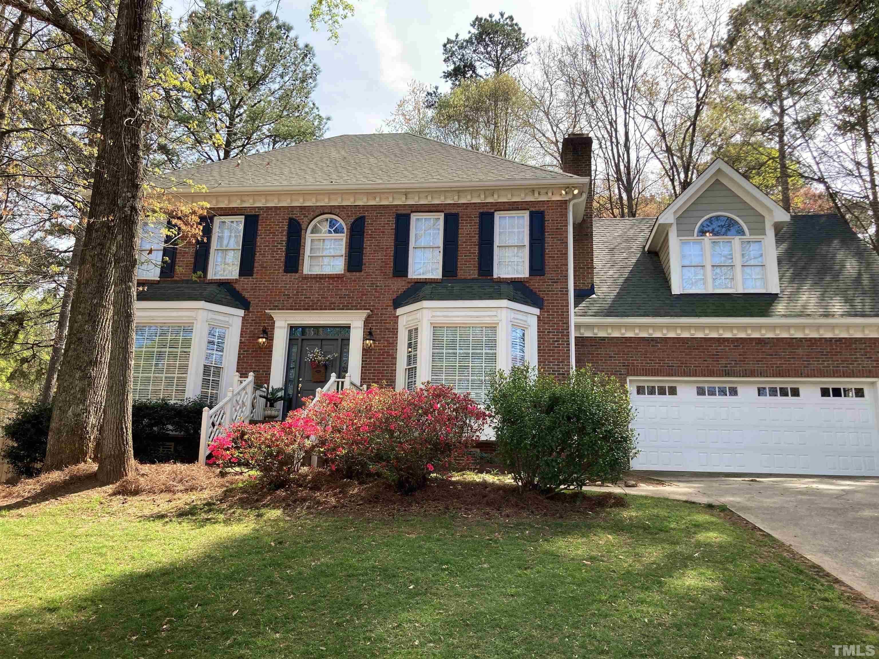 7608 Tylerton Drive Raleigh, NC 27613 - Photo 1 of 48 a front view of a house with garden