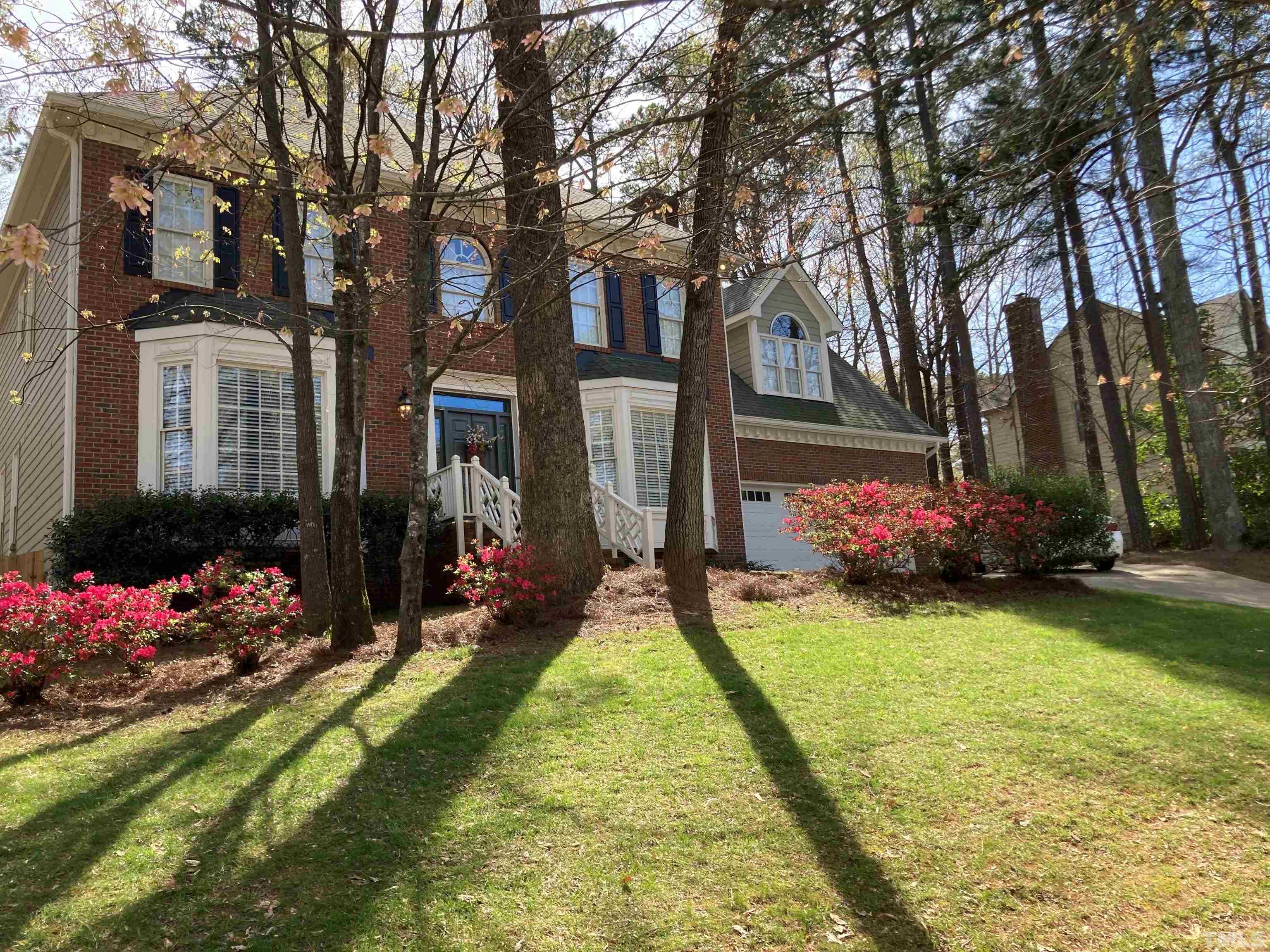7608 Tylerton Drive Raleigh, NC 27613 - Photo 4 of 48 a view of a house with a big yard and large trees