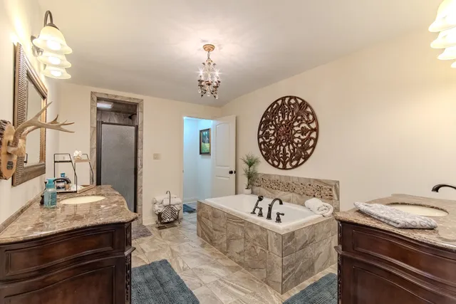 a view of a kitchen with a sink and chandelier