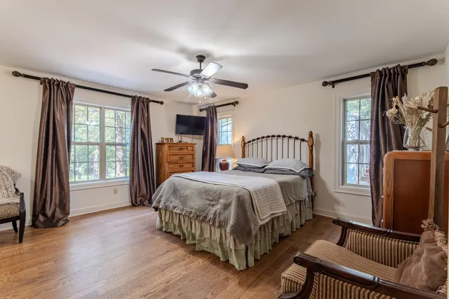 a bedroom with a bed closet and a flat tv screen