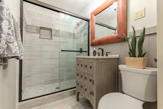 a bathroom with a sink toilet and shower