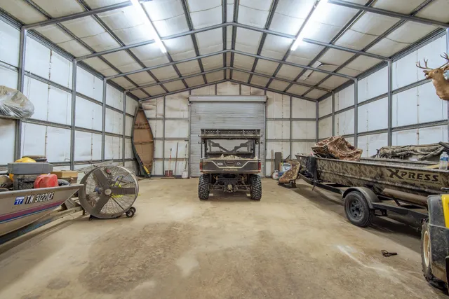 a garage with a car furniture and tools shelf