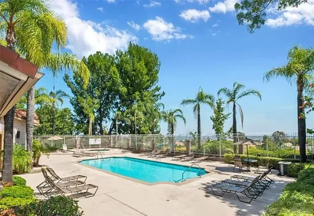 a view of swimming pool with chairs