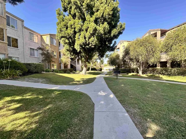 a view of yard with swimming pool and green space