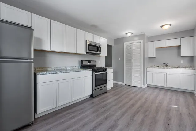 a kitchen with a white cabinets and white appliances
