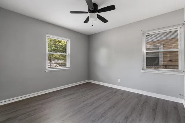 a view of a room with wooden floor and windows
