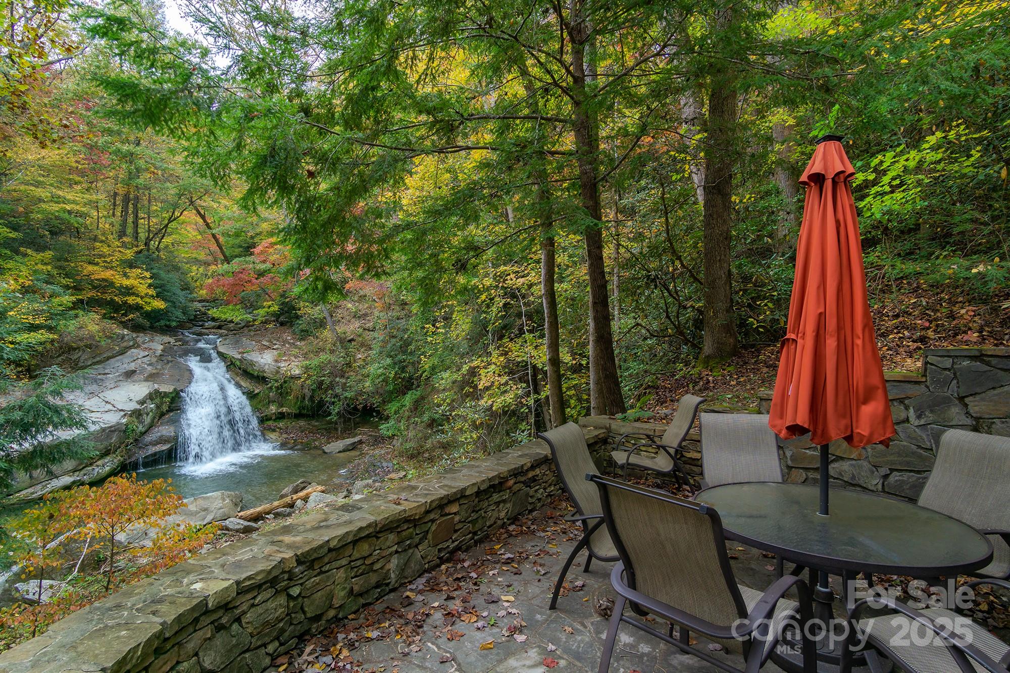 401 Winterle Road Black Mountain, NC 28711 - Photo 40 of 44 a view of a backyard with table and chairs a fire pit