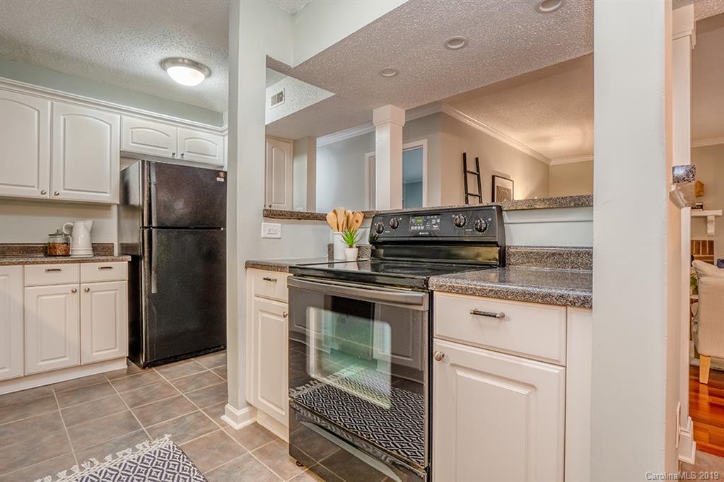 4948 Sardis Road, Unit B Charlotte, NC 28270 - Photo 11 of 30 a kitchen with a sink stove and refrigerator