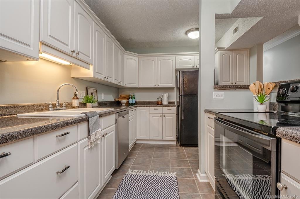 4948 Sardis Road, Unit B Charlotte, NC 28270 - Photo 12 of 30 a kitchen with white cabinets and appliances