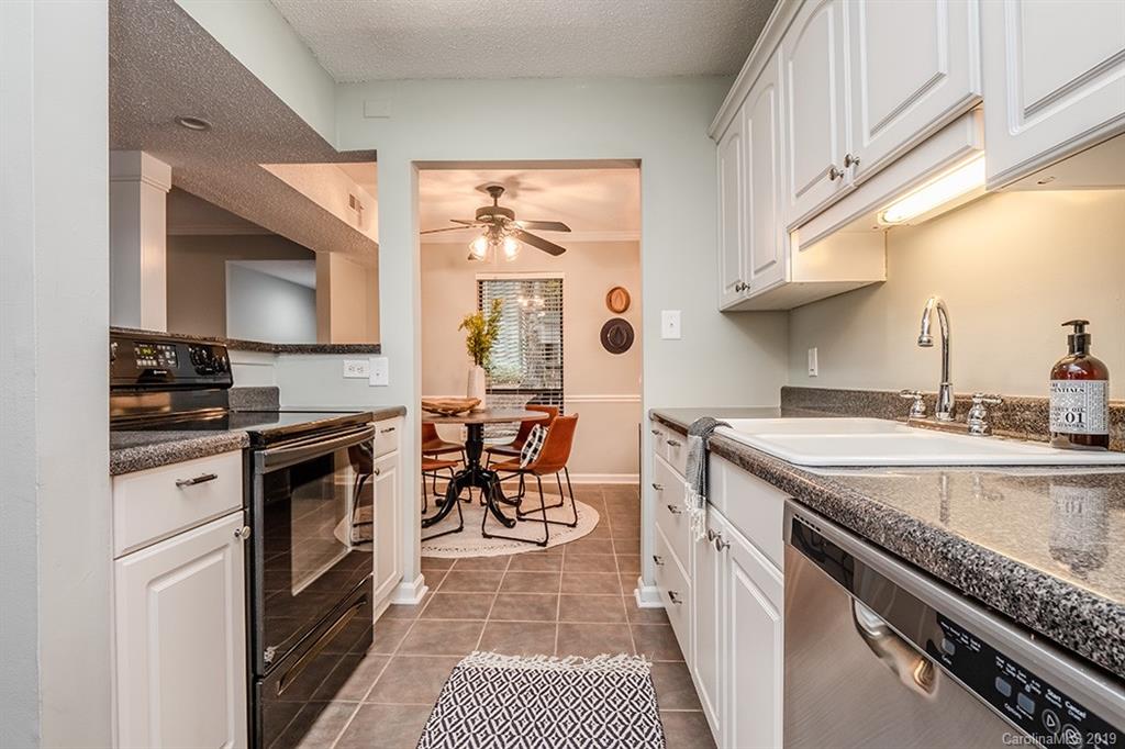 4948 Sardis Road, Unit B Charlotte, NC 28270 - Photo 13 of 30 a kitchen with stainless steel appliances granite countertop a stove a sink and a microwave