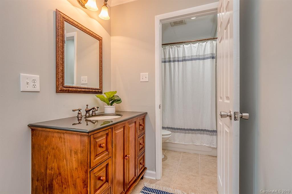 4948 Sardis Road, Unit B Charlotte, NC 28270 - Photo 16 of 30 a bathroom with a sink a mirror and a window