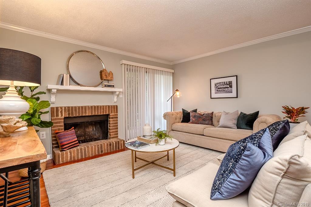 4948 Sardis Road, Unit B Charlotte, NC 28270 - Photo 4 of 30 a living room with furniture a fireplace a rug and a window