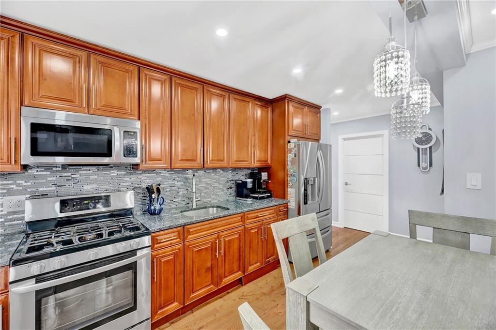 2241 Plumb 1st Street, Unit 5M Brooklyn, NY 11229 - Photo 11 of 24 a kitchen with stainless steel appliances granite countertop a stove top oven a sink dishwasher a refrigerator and a microwave