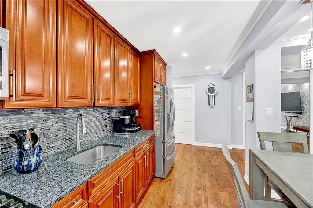 2241 Plumb 1st Street, Unit 5M Brooklyn, NY 11229 - Photo 12 of 24 a kitchen with sink a refrigerator and cabinets