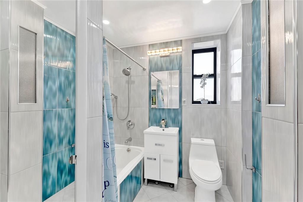 2241 Plumb 1st Street, Unit 5M Brooklyn, NY 11229 - Photo 18 of 24 a bathroom with a toilet a sink and shower