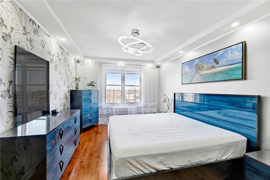 2241 Plumb 1st Street, Unit 5M Brooklyn, NY 11229 - Photo 20 of 24 a bedroom with a bed and dresser with mirror