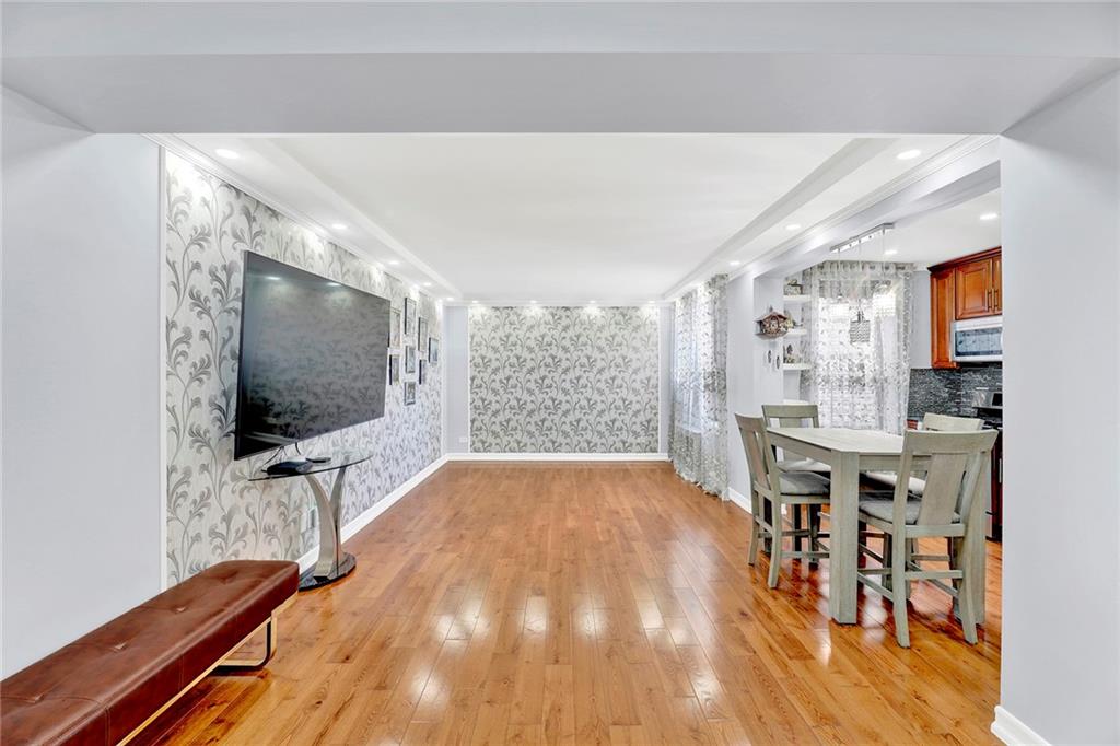 2241 Plumb 1st Street, Unit 5M Brooklyn, NY 11229 - Photo 2 of 24 a living room with furniture and a flat screen tv