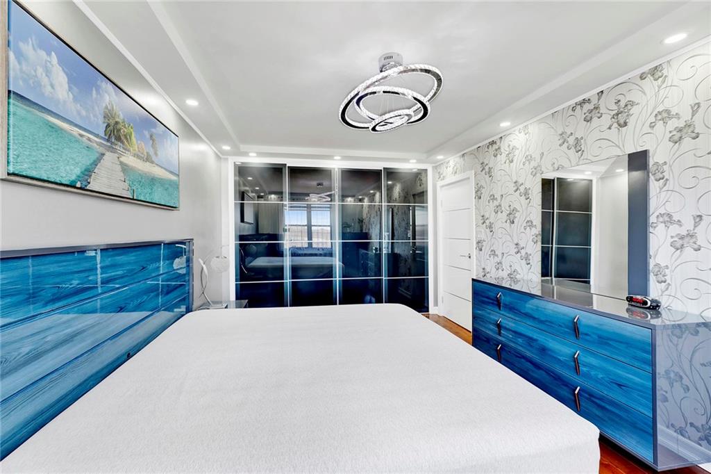 2241 Plumb 1st Street, Unit 5M Brooklyn, NY 11229 - Photo 21 of 24 a view of a room with a large bed and wooden floor