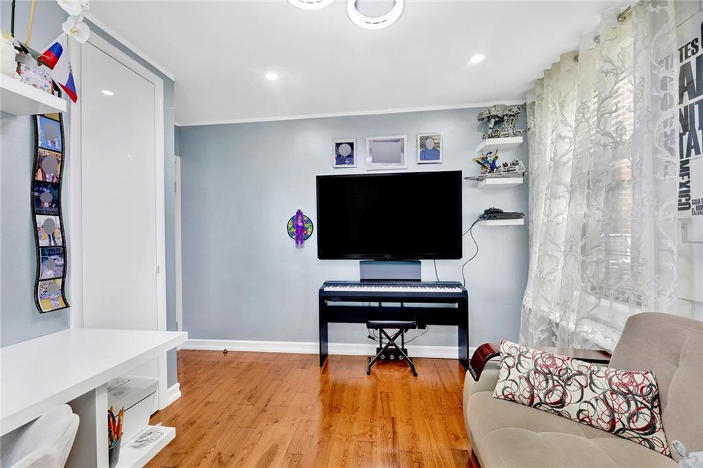 2241 Plumb 1st Street, Unit 5M Brooklyn, NY 11229 - Photo 23 of 24 a living room with furniture and a flat screen tv