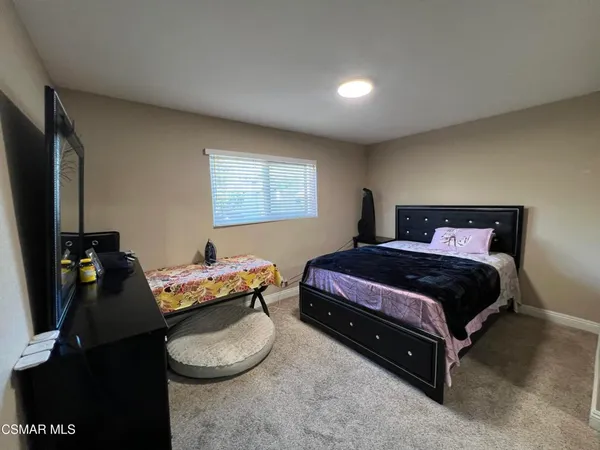 a bedroom with a bed and a television