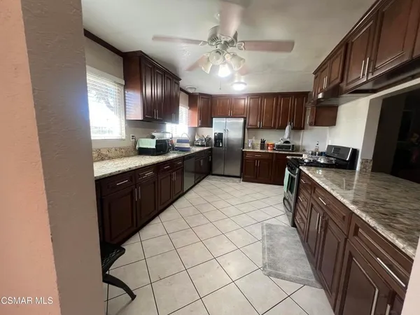 a kitchen with granite countertop a stove and a sink