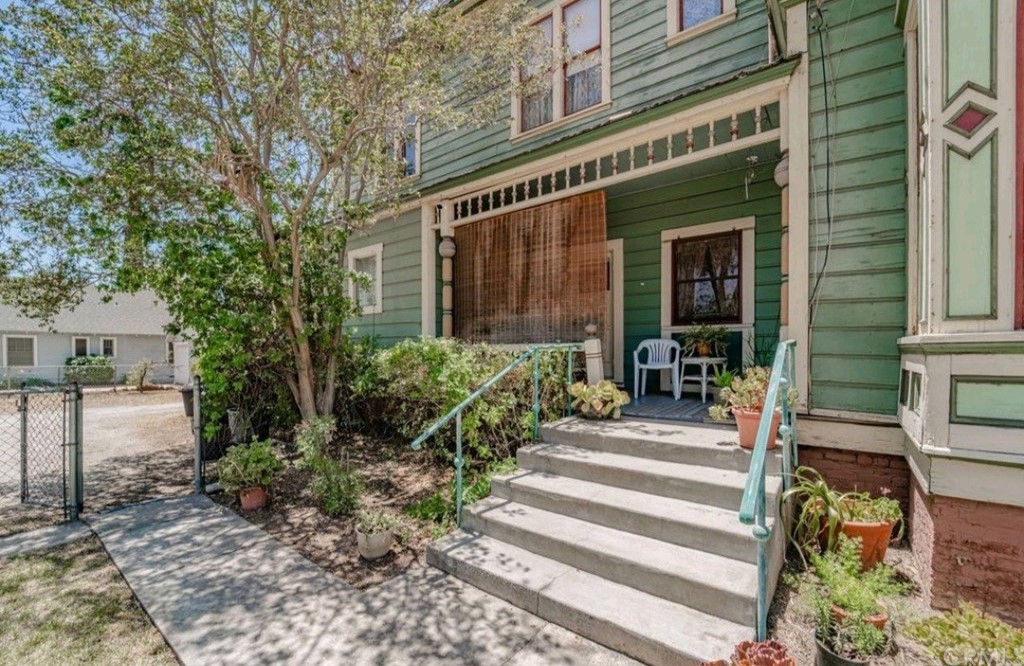 3121 Mulberry Street Riverside, CA 92501 - Photo 18 of 67 a front view of a house with plants and large trees