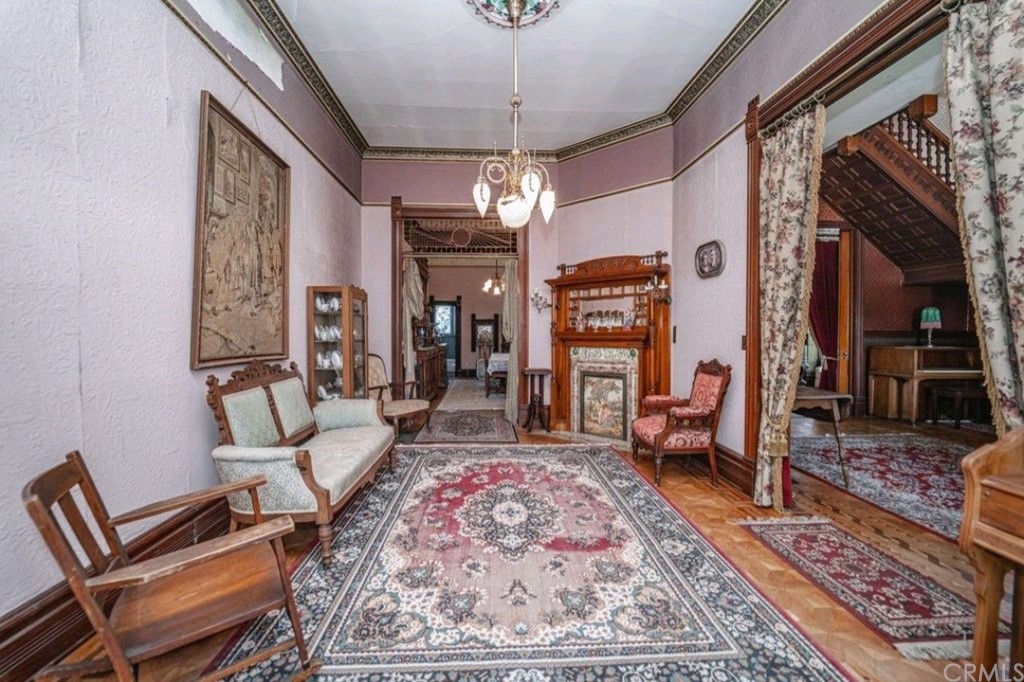 3121 Mulberry Street Riverside, CA 92501 - Photo 46 of 67 a living room with furniture a rug and a chandelier