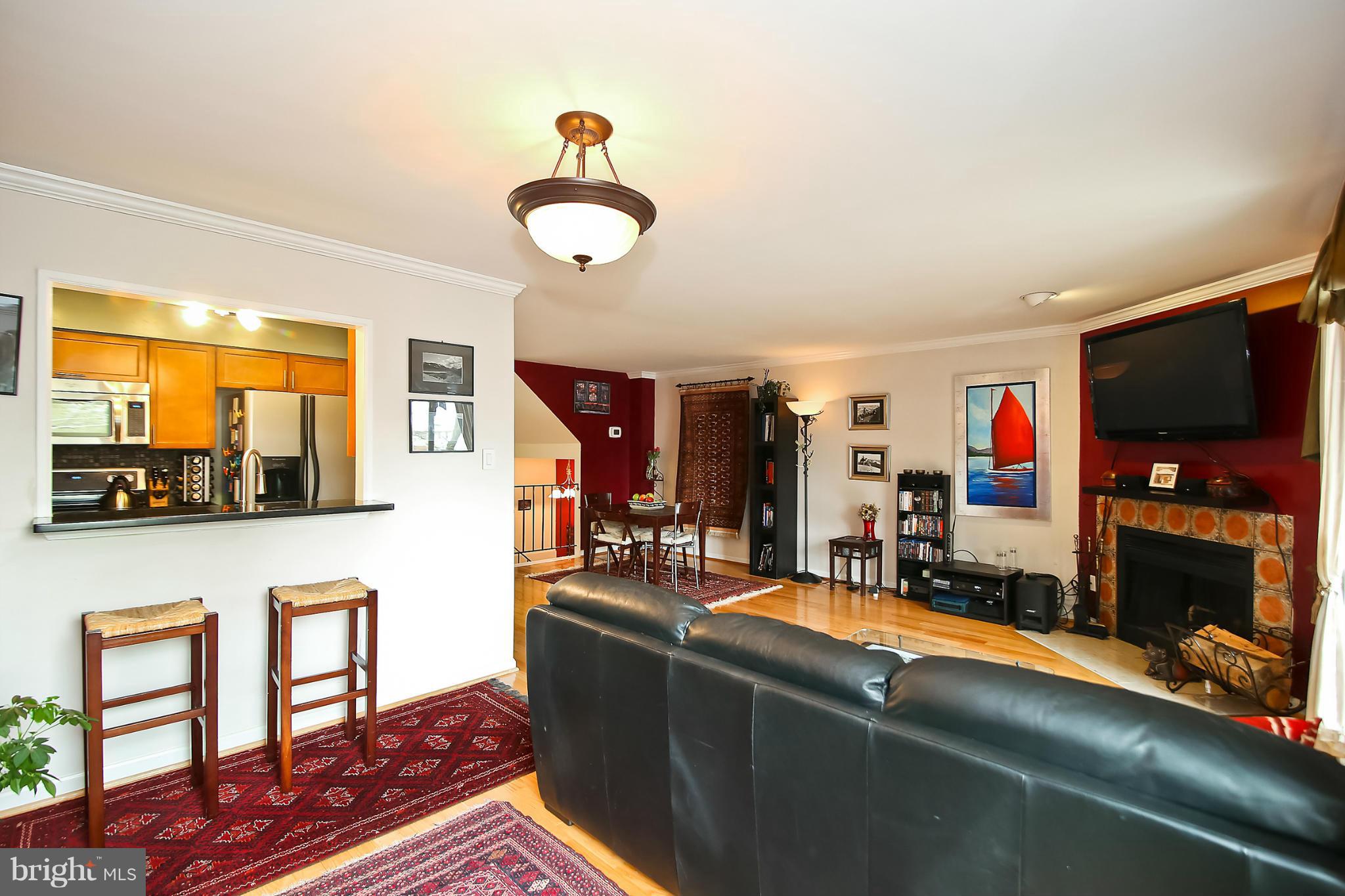 2103 North Rolfe Street, Unit A Arlington, VA 22209 - Photo 18 of 28 a living room with furniture and a flat screen tv