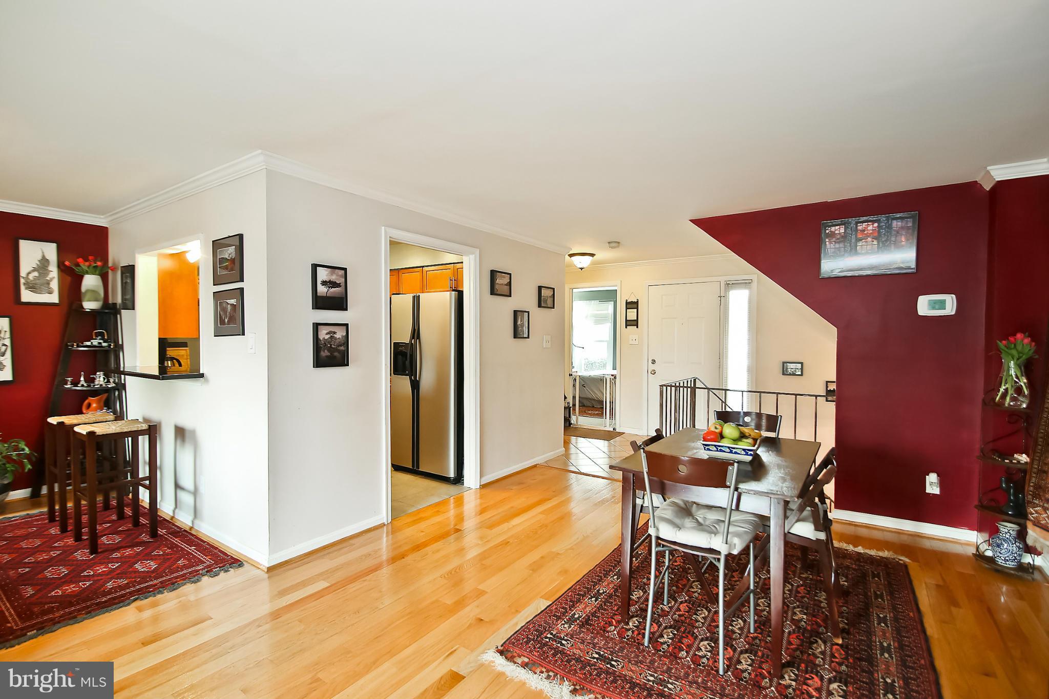 2103 North Rolfe Street, Unit A Arlington, VA 22209 - Photo 3 of 28 a view of a dining room with furniture and wooden floor