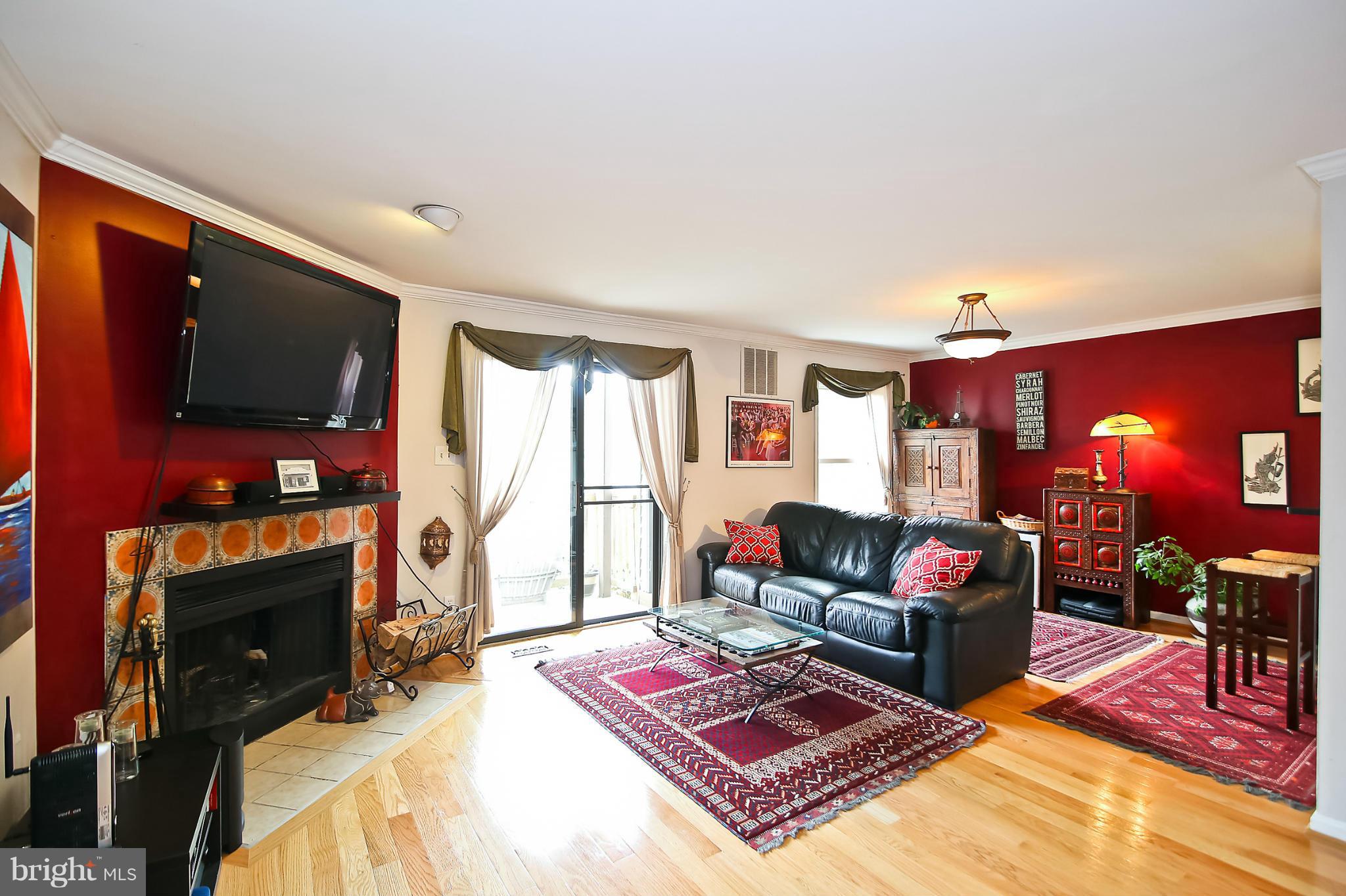 2103 North Rolfe Street, Unit A Arlington, VA 22209 - Photo 22 of 28 a living room with furniture a flat screen tv and a flat screen tv