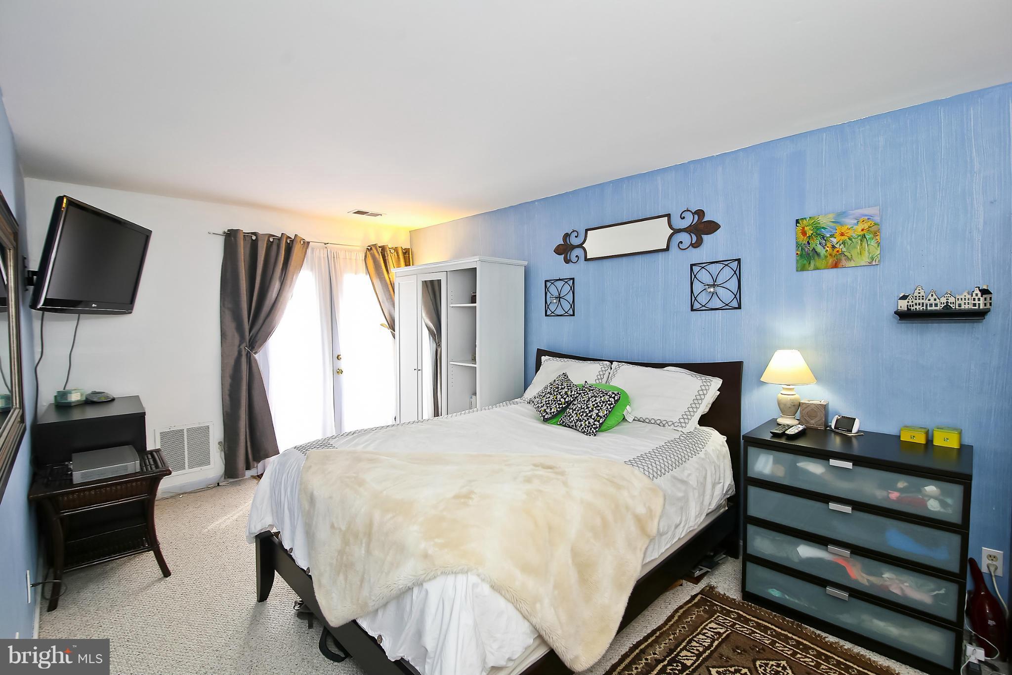 2103 North Rolfe Street, Unit A Arlington, VA 22209 - Photo 4 of 28 a bedroom with a bed and a walk in closet