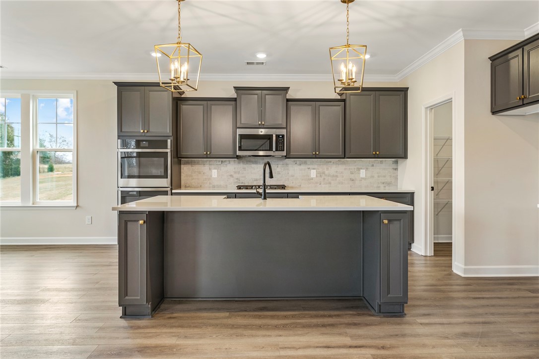 3140 Midway Road Anderson, SC 29621 - Photo 11 of 39 This kitchen features sleek cabinetry and an inviting island, perfect for culinary endeavors and gatherings.