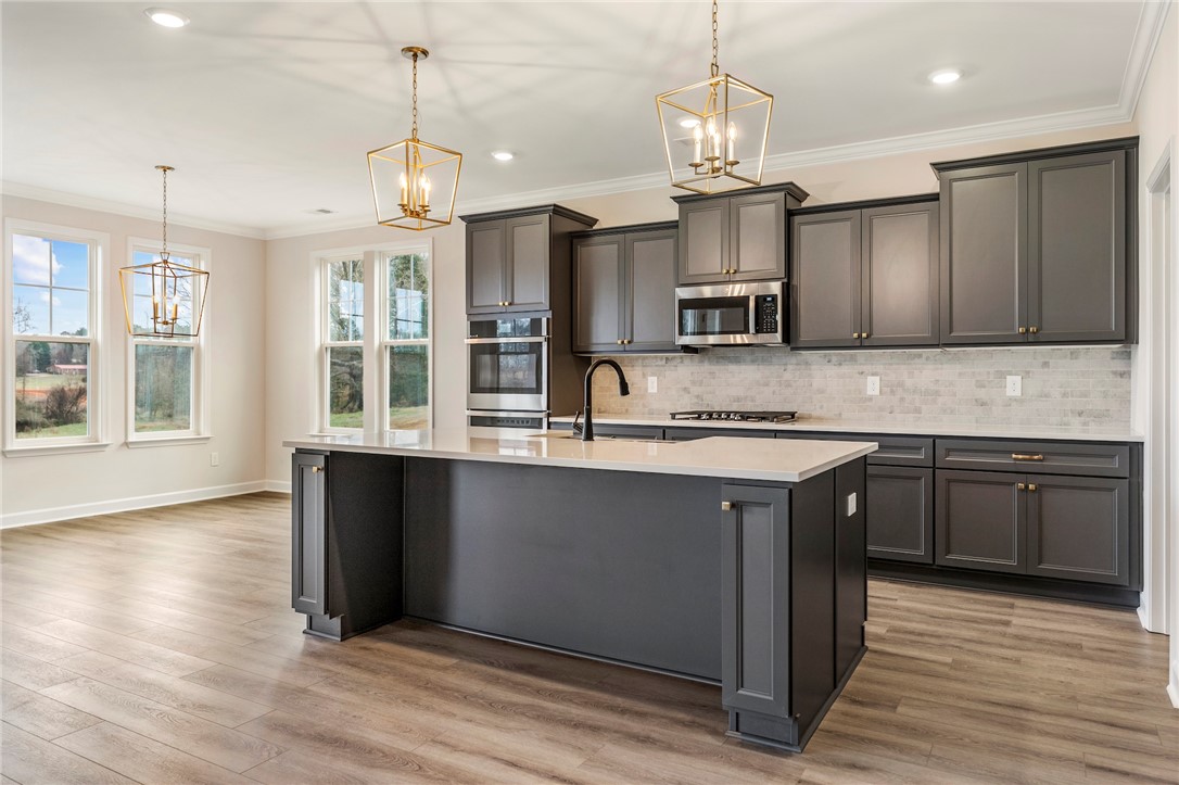 3140 Midway Road Anderson, SC 29621 - Photo 12 of 39 This kitchen features a central island, ample cabinetry, and stainless steel appliances.