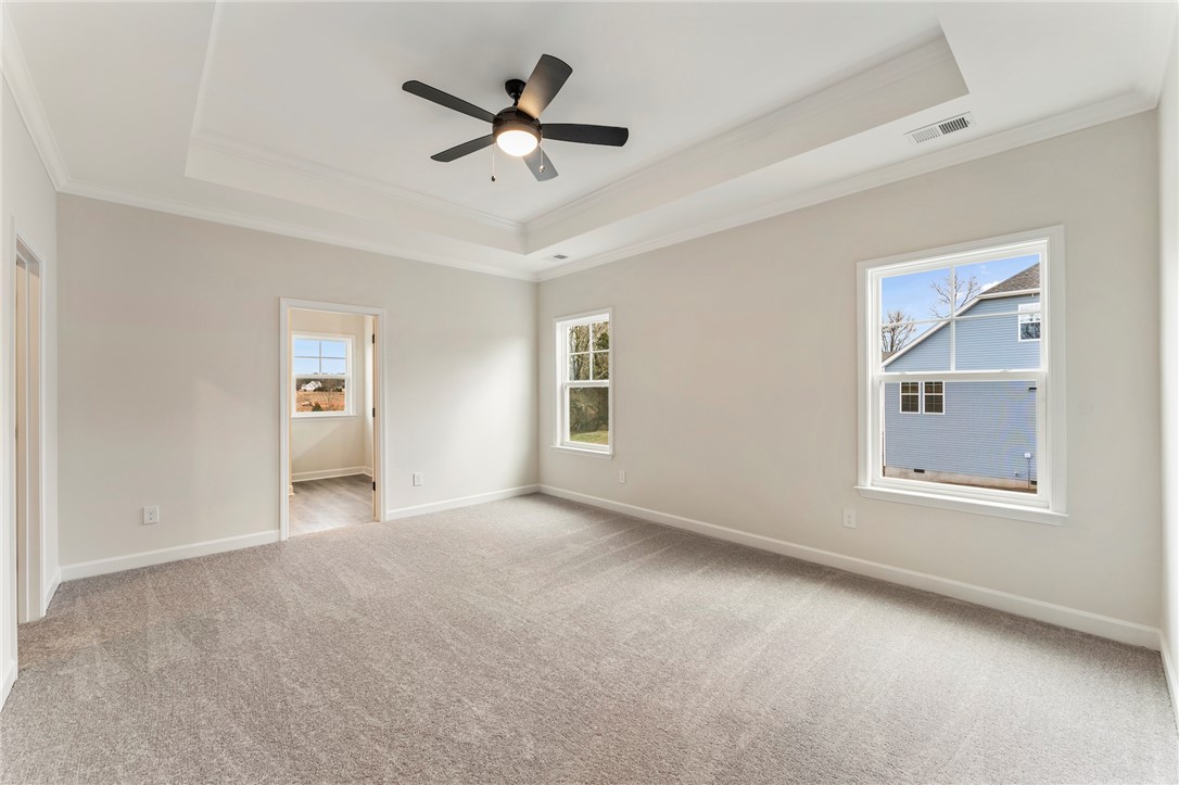 3140 Midway Road Anderson, SC 29621 - Photo 17 of 39 This primary bedroom offers ample space, soft carpeting, and a ceiling fan for comfort.