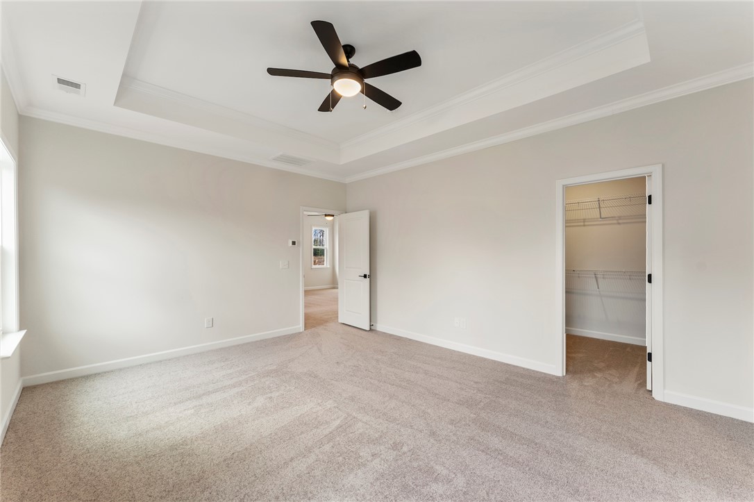 3140 Midway Road Anderson, SC 29621 - Photo 18 of 39 This spacious primary bedroom features soft carpeting, a ceiling fan, and ample closet space.